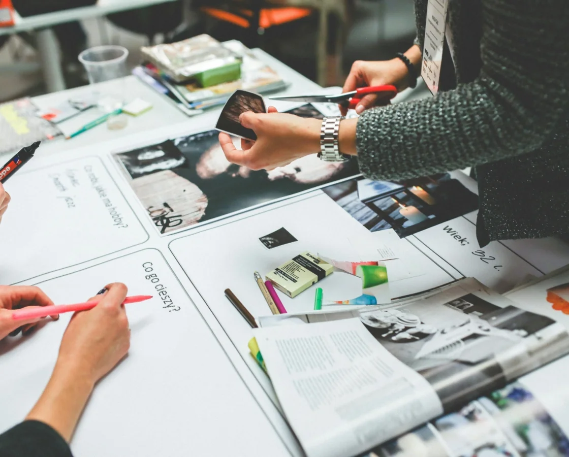 Creative team crafting visual layouts & brand assets during a creative direction session